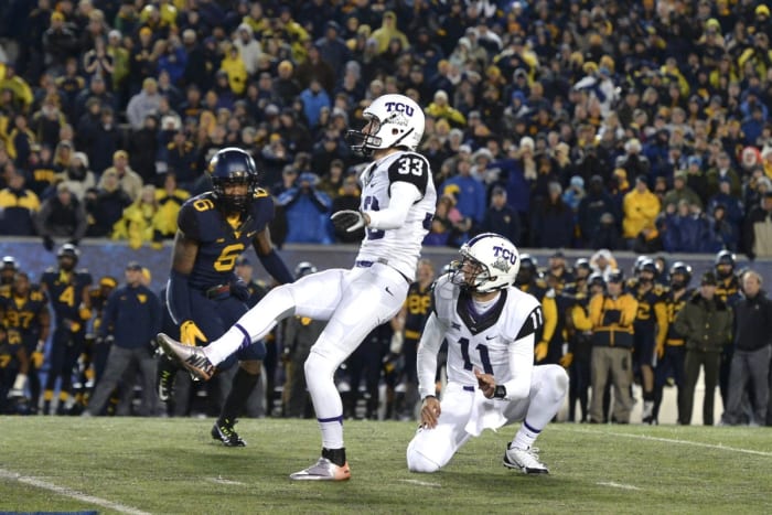 Nov 1, 2014; Morgantown, WV, USA; TCU Horned Frogs place kicker Jaden Oberkrom (33) kicks the game winning field goal as time expires in the fourth quarter against the West Virginia Mountaineers at Milan Puskar Stadium. TCU defeated West Virginia, 31-30.